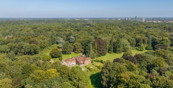 luchtfoto met zicht op het Lichtbos en Landhuis De Wielewaal